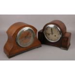 Two oak cased 8 day mantel clocks, both by Norland Clock Company. One with pendulum and key.