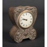 An Art Nouveau silver cased desk clock by Douglas Clock Co. Decorated in relief with stylized