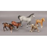 Three Beswick Horse figures, Dapple grey, Palomino foal and two similar examples