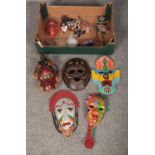 A box of tourist masks to include tribal style, Cuban leather examples, etc.