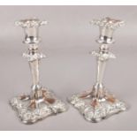 A pair of Sheffield plate candlesticks with detachable nozzles. (Height 20cm).
