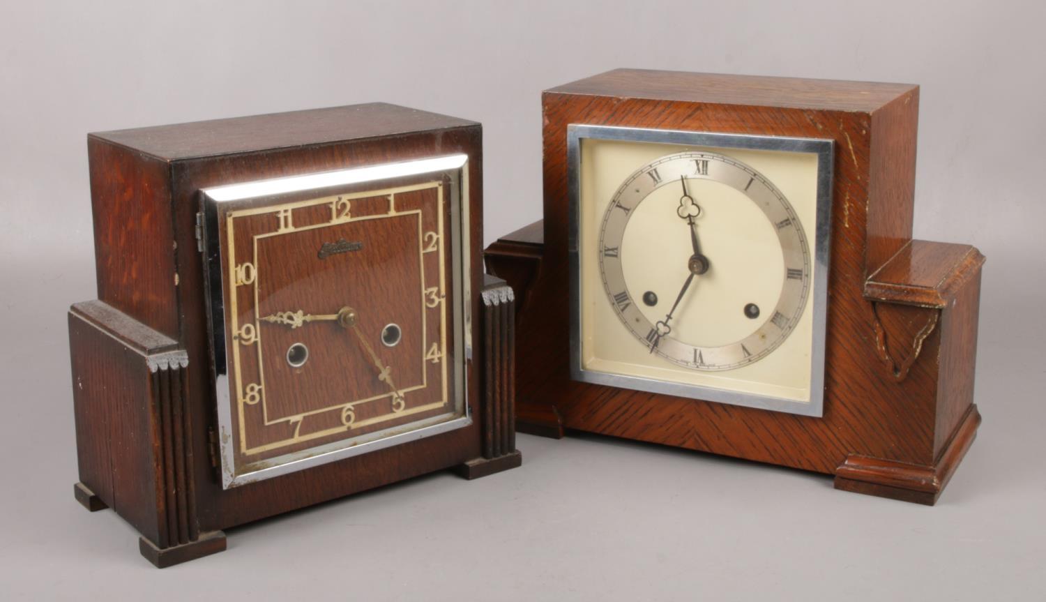 Two Art Deco carved oak 8 day mantel clocks, one by Bentima, both with pendulums.