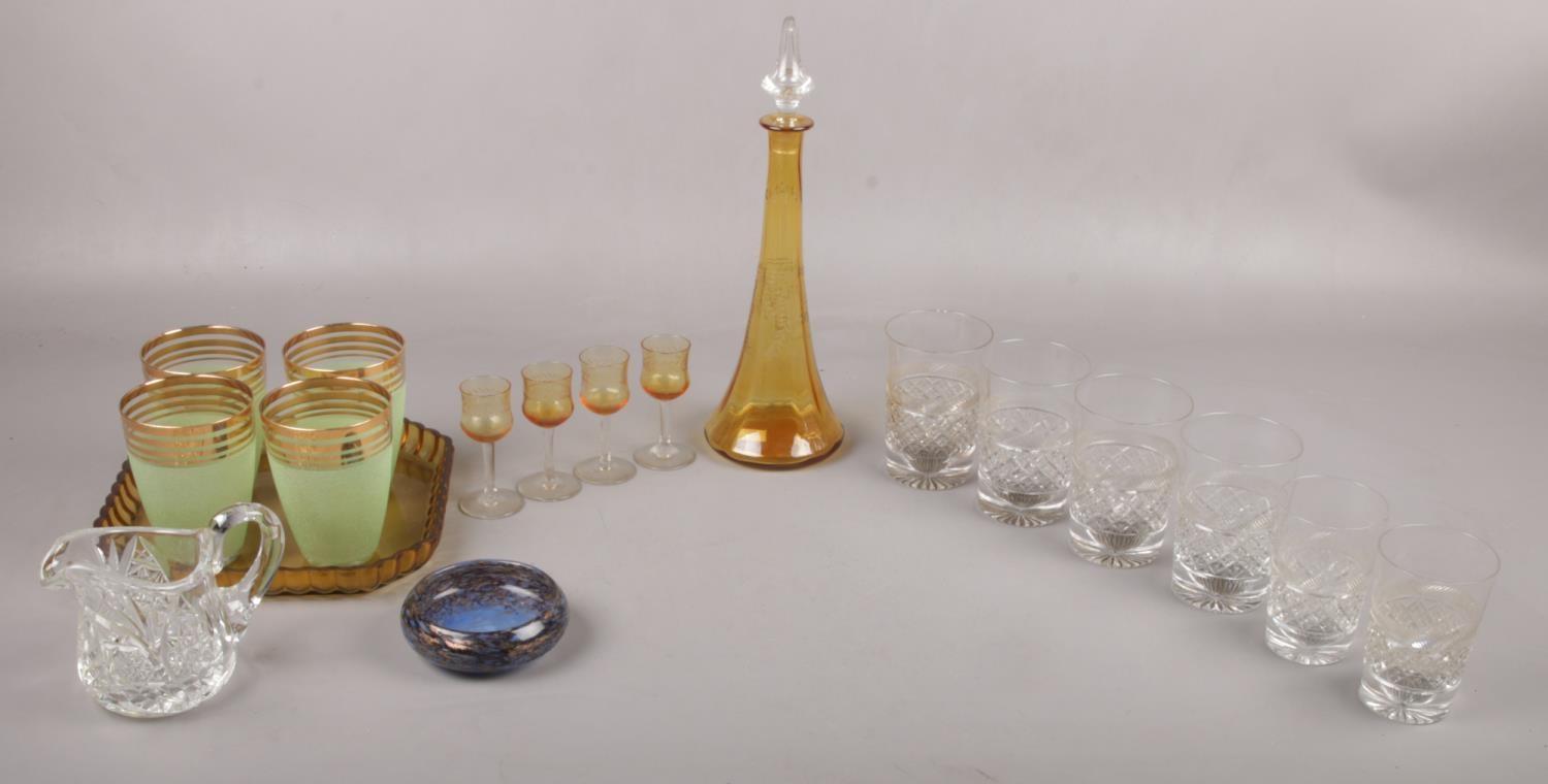 A selection of glassware to include, an amber coloured decanter together with four port/sherry