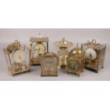 Six brass clocks, to include torsion examples, Schatz two jewel, Smiths lantern clock etc.