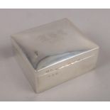 A silver cigarette box assayed Birmingham 1913 by William Aitken. (gross weight 307g). Dents to