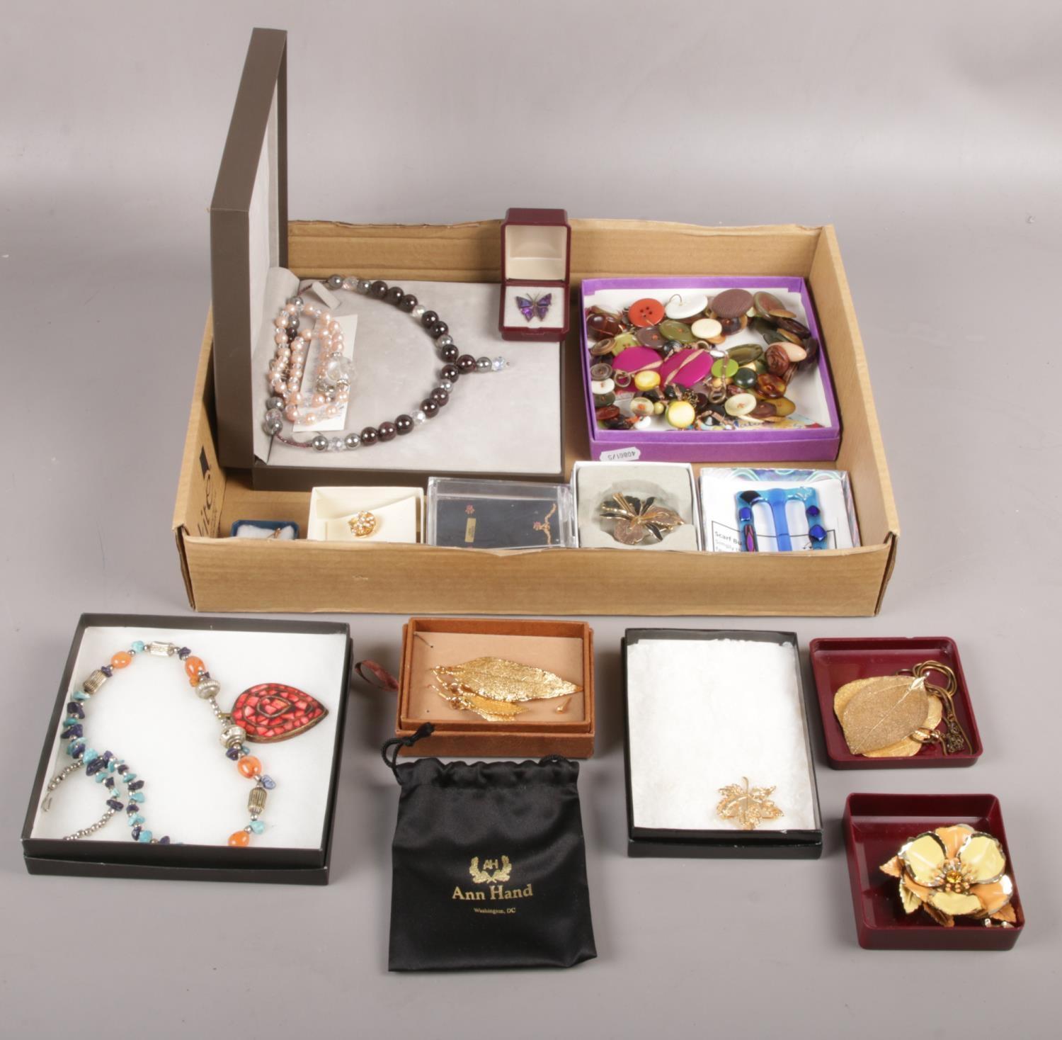 A tray of of cased dress jewellery to include ruby pendant & earrings set, garnet bead set, gilt