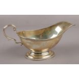 A George V silver sauceboat assayed London 1910 by S W Smith & Co. (172g).