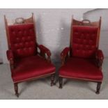 A pair of Victorian carved mahogany shallow button upholstered fireside armchairs.