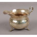 A George V silver cream jug assayed Birmingham 1910 by William Aitken. (104g).