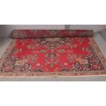 A vintage red ground Persian Tabriz carpet, with floral design. (300cm x 195cm).