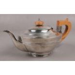 A silver teapot with oak handle and turned finial, assayed Birmingham 1911 by Elkington & Co. (gross