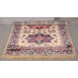 A gold ground Kashmir rug with Aztec design. (170cm x 120cm).