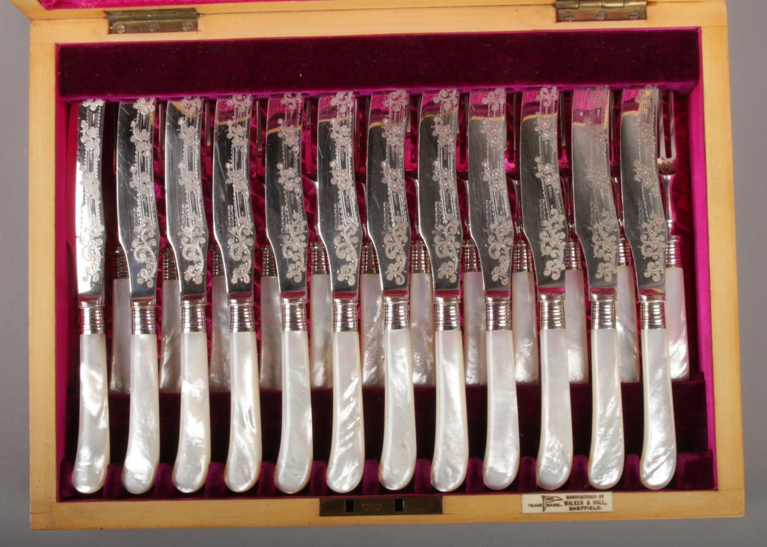 A mahogany cased set of twelve Walker & Hall mother of pearl handled dessert knives and forks. - Image 2 of 2