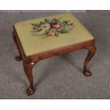 A wooden piano stool with upholstered floral tapestry style top. (Height 42cm, length 52cm & width