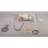 A large collection of costume jewellery to include, a selection of faux pearl necklaces, bangles,