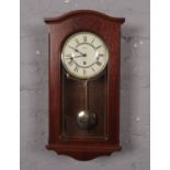 A Acctim wooden cased wall clock