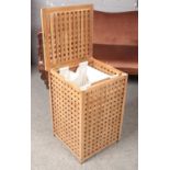 A wooden laundry basket with pull up lid and cotton bag inside. (68cm height x 46.5cm width).