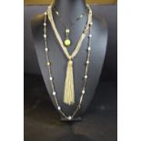 Three costume necklaces: Gold tassel 1960s, yellow conemara marble necklace circa 910 and Agate