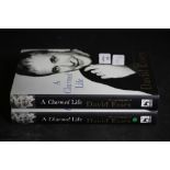 Essex [David], two copies of A Charmed Life, both signed first editions