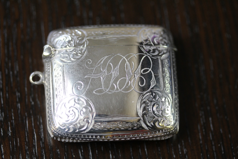 Edward VII silver vesta case by W.A., curved body with scroll bordered cartouche decorated to front,