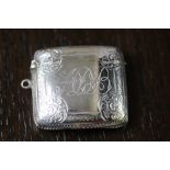 Edward VII silver vesta case by W.A., curved body with scroll bordered cartouche decorated to front,