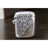 Edward VII silver vesta case, curved body engraved with leaf scrolls by G.W., Chester 1907 (some
