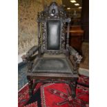 Pair of Victorian carved oak 'Throne' armchairs of Carolean design, each with twin lion crestings,