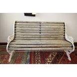 Victorian white painted cast iron garden bench in the Coalbrookdale manner, oak slatted seat,