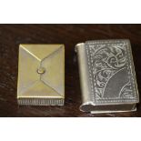 Early 20th century plated brass envelope form vesta case (worn) and a plated book form vesta case