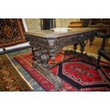 Victorian heavily carved oak centre table of Gothic design, fitted single drawer, on twin turned end
