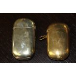 Two Victorian large ovoid vesta cases, one brass, the other plated with open buckle cartouche