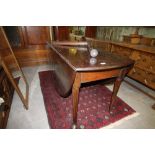 Early George III mahogany drop leaf oval dining table