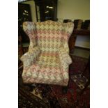 19th century Irish wing-back armchair with Donegal style upholstery