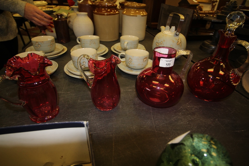 Cranberry glass decanter & 3 jugs