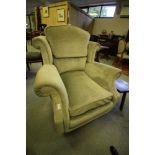 Green upholstered winged armchair
