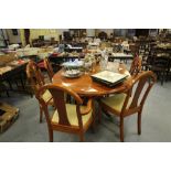 Figured veneer dining table and six chairs by Barr