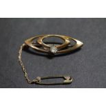 Gilt metal oval white stone brooch