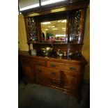 Walnut arts and crafts period mirror backed sideboard with bowed and glazed cupboards to the
