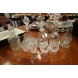 5 Cut Glass Decanters with 2 silver labels, 1 ceramic label, 2 others and 4 glasses with spare