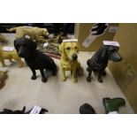 Three Leonardo sitting black Labradors