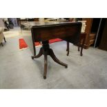 George IV figured mahogany drop leaf Pembroke table, with two dummy drawers, on turned central