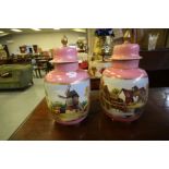A pair of Continental porcelain lidded urns, each enamelled to front with named views, worded