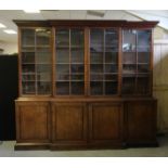 George III mahogany breakfront bookcase, with moulded and dentil cornice, upper part enclosed by