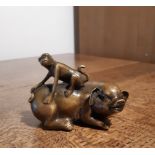 Chinese cast bronzed metal model of a monkey astride a pig, character marks to reverse, 10cm high