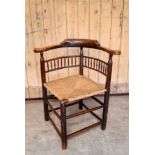 Interesting late 18th / early 19th Century elm corner armchair, with turned splat, rush seat, some