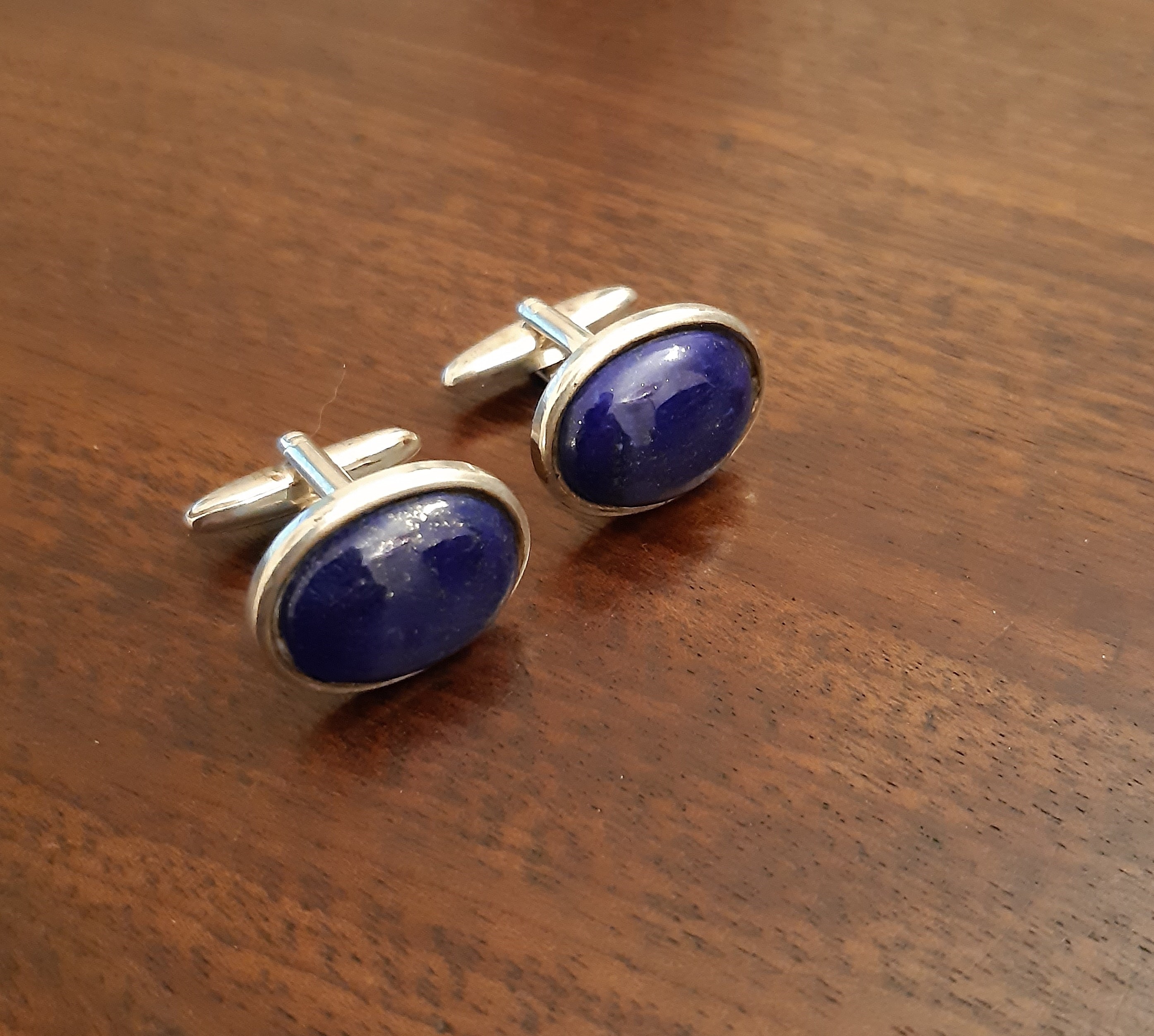 Pair white metal and lapis lazuli cufflinks, with oval cabochon faces