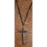 White metal and hardwood crucifix, 9.5cm high, with bead necklace