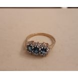 9ct gold blue and clear stone ring, set with three oval blue stones surrounded by small circular