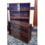 Three Mid century stained pine low bookcases, each with sliding glass doors, one with a plinth, each