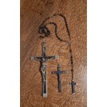 White metal and ebony Crucifix, 20cm high, a smaller similar ditto, 9.5cn high, together with a